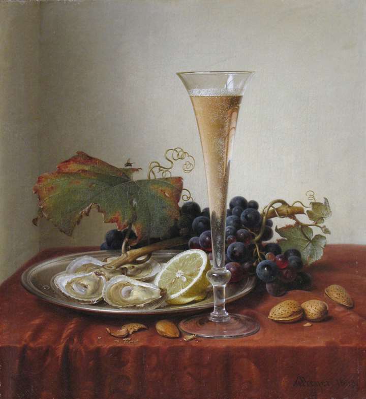Grapes, oysters, almonds and a Champagne flute on a draped ledge